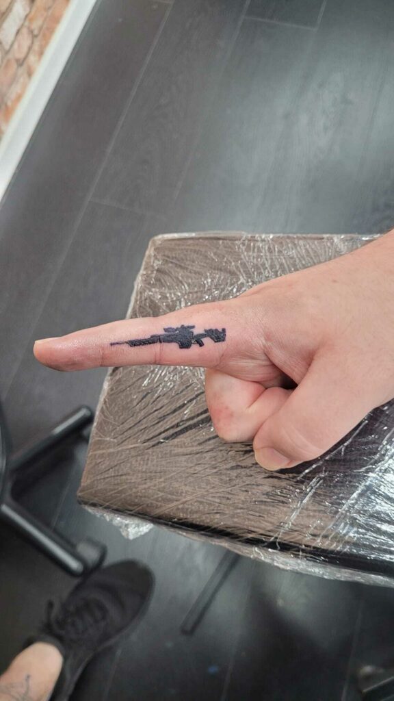 Gun Finger Black and White Tattoo