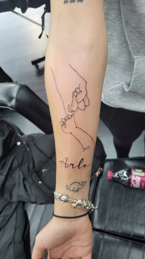 Holding Hand Women Forearm Black and White Tattoo