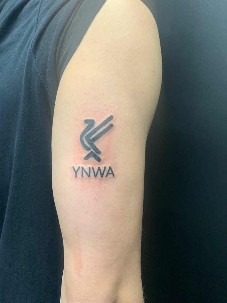 YNWA Logo Biceps Black And White Tattoo